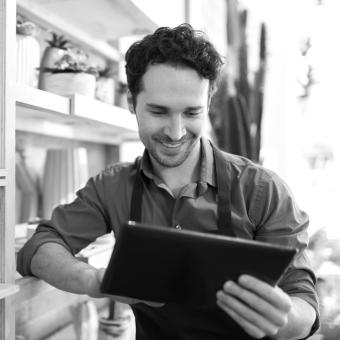 Man signing document on tablet device